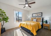 Thumbnail 10 of 35 - a bedroom with a yellow bed and a ceiling fan