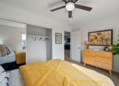 Thumbnail 9 of 35 - a bedroom with a bed and a ceiling fan
