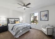 Thumbnail 12 of 35 - a bedroom with a bed and a ceiling fan