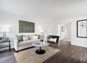 Thumbnail 4 of 29 - a living room with a couch and a coffee table