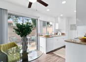 Thumbnail 7 of 29 - a kitchen and dining room with a glass table