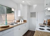 Thumbnail 9 of 29 - a kitchen with white cabinets and a counter top and a sink