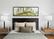 Thumbnail 11 of 29 - a bedroom with a bed and a painting on the wall
