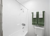 Thumbnail 14 of 29 - a bathroom with a toilet and a shower and towels
