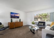 Thumbnail 3 of 57 - a living room with white walls and a large window