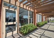 Thumbnail 21 of 35 - the entrance to a fitness center with awning and glass windows