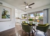 Thumbnail 4 of 57 - a dining area with a table and chairs and a ceiling fan