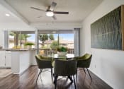 Thumbnail 6 of 57 - a dining area with a table and chairs and a ceiling fan