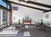 Thumbnail 17 of 35 - a dining room with tables and chairs and a large window