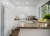 Thumbnail 39 of 57 - a kitchen with white cabinets and white appliances