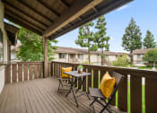 Thumbnail 35 of 57 - two chairs with yellow pillows sit on a wooden deck with trees in the background