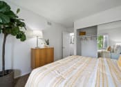 Thumbnail 7 of 57 - a bedroom with a yellow and white bedspread