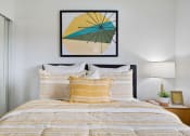 Thumbnail 8 of 57 - a bedroom with a bed with yellow and white bedding and a framed picture above the bed