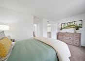 Thumbnail 42 of 57 - a bedroom with a bed and a dresser