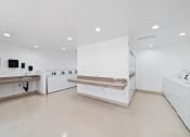 Thumbnail 28 of 29 - a kitchen with counters and sinks in a white room