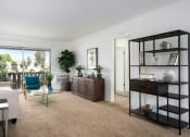 Thumbnail 49 of 57 - a living room with white walls and a brown carpet
