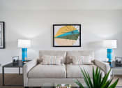 Thumbnail 48 of 57 - a living room with a beige couch and two blue lamps