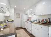 Thumbnail 51 of 57 - a kitchen with white cabinets and white appliances