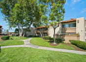 Thumbnail 29 of 29 - a building with trees and a sidewalk in front of it