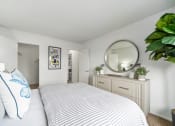 Thumbnail 55 of 57 - a bedroom with a large bed and a mirror