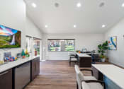 Thumbnail 32 of 35 - a living room with a kitchen and a dining room