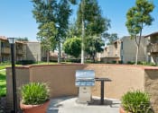 Thumbnail 21 of 29 - a grill in a courtyard in front of an apartment building