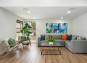Thumbnail 15 of 57 - a living room with white walls and hardwood flooring