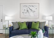 Thumbnail 3 of 41 - a living room with a blue couch and green pillows