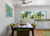 Thumbnail 2 of 41 - a dining room with a table and chairs and a ceiling fan