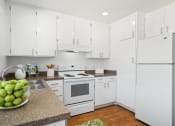Thumbnail 8 of 41 - a white kitchen with white appliances and white cabinets