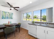 Thumbnail 7 of 41 - a kitchen and dining room with a large window and a ceiling fan
