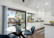 Thumbnail 7 of 24 - a kitchen and dining area with a glass table and chairs