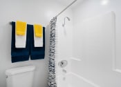 Thumbnail 17 of 24 - a bathroom with a shower and two towels on a rack