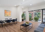 Thumbnail 31 of 41 - a dining room with a table and chairs and a large window