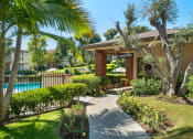 Thumbnail 23 of 41 - a sidewalk in front of a house with a swimming pool