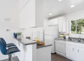 Thumbnail 8 of 68 - a kitchen with white cabinets and a counter top and a sink