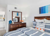 Thumbnail 24 of 68 - a bedroom with a bed and a mirror and a bathroom