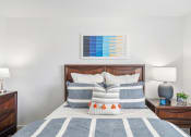 Thumbnail 22 of 68 - a bedroom with a bed with blue and white pillows