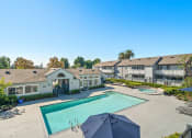 Thumbnail 33 of 68 - the view of a swimming pool with apartments in the background