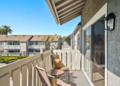 Thumbnail 31 of 68 - a terrace with chairs and a table and a view of a building and a