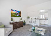 Thumbnail 36 of 68 - a living room with a couch and a glass coffee table
