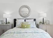 Thumbnail 38 of 68 - a bedroom with a bed with a green and white comforter and pillows