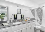 Thumbnail 41 of 68 - a white bathroom with a sink and a toilet