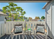 Thumbnail 11 of 68 - a balcony with two chairs and a table