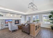 Thumbnail 68 of 68 - a living room with a stone fireplace and a wood floor