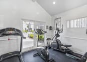 Thumbnail 51 of 68 - the gym has plenty of cardio equipment and a sliding glass door to the patio