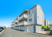 Thumbnail 58 of 68 - a row of apartment buildings with balconies and garages