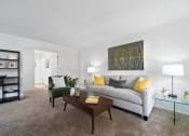 Thumbnail 4 of 32 - a living room with a couch and a coffee table