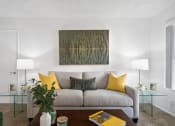 Thumbnail 5 of 32 - a living room with a couch and a table