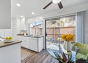 Thumbnail 10 of 32 - an open kitchen and dining area with a glass table and chairs